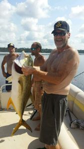Three people on a tour boat in Gulf Breeze