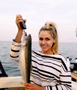 Angler holding a 16-inch fish in Toronto, fishing