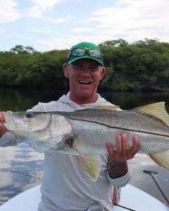 A fisherman with a large snook catch in Jupiter, Florida