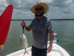 A lone fisherman reeling in a catch in Florida
