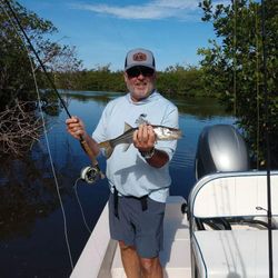 A person fishing with a rod in FL