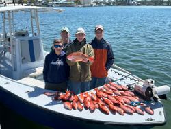 Successful lane snapper fishing trip in Pensacola FL with large catch displayed on boat deck