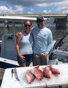 2 people fishing in Pensacola with 2 fish