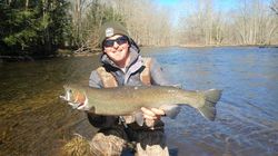 Angler with a large rainbow trout caught in NY