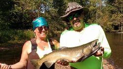 A fisherman with a rainbow trout caught in NY