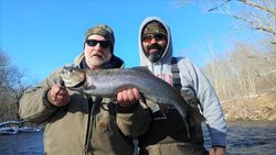 A rainbow trout fish caught by two people in Pulaski