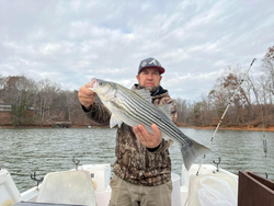 Fisherman holding a striped bass in Cumming