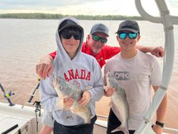 Blue catfish catch on fishing boat in Mannford OK with three anglers displaying their successful fishing trip