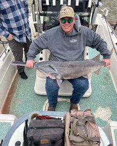 Two people fishing in Mannford with a 23-inch fish