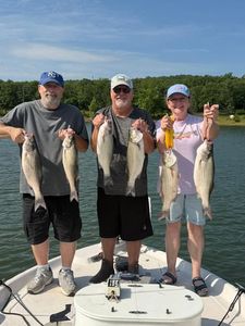 Successful fishing trip in Mannford OK showing multiple striped bass caught on boat