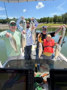 Successful fishing trip in Mannford OK with striped bass and white bass catch displayed on boat