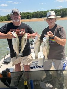 Successful striped bass fishing trip in Mannford OK showing fresh caught fish on boat