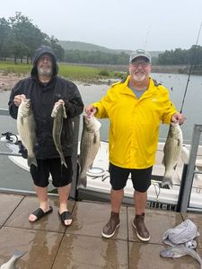 Successful striped bass and white bass fishing catch displayed on boat dock in Mannford OK