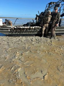Three people in a fishing boat on the water in Port Mansfield