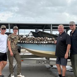Four people enjoying fishing adventure in TX