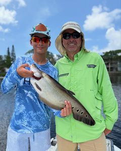 A pair of anglers in Homestead with their catch