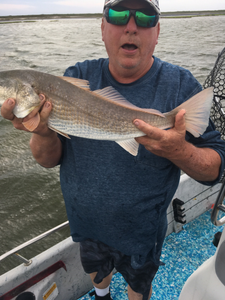 A single fisherman enjoying a scenic view in Port Aransas