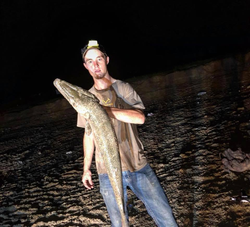 Lone angler fishing with rod and reel in orange location