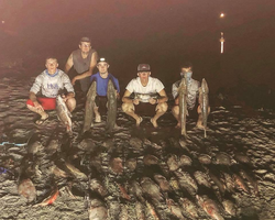 2 big orange-colored fish caught on fishing trip