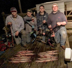 Four people enjoying fishing in the orange outdoors