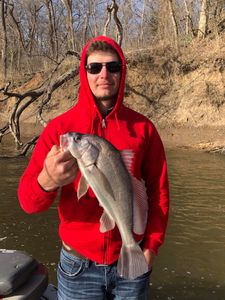 A person fishing in Oklahoma with a single fish