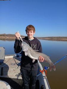 Angler with a big white catfish on the line in OK