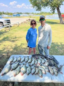 Two anglers fishing in Lewisville, with three fish caught