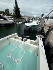 Fishing boat docked at marina in Bridge Florida with outboard motor and fishing deck