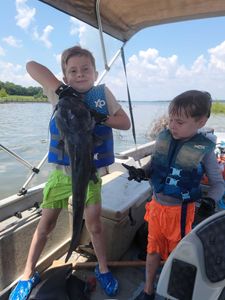 Two people fishing with a single big fish in Grand Saline