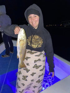 Three anglers with a big fish in Gulf Shores