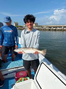 Angler holding caught fish on fishing boat in Gulf Shores AL