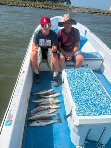 Successful fishing trip in Gulf Shores AL showing multiple fish species caught on boat