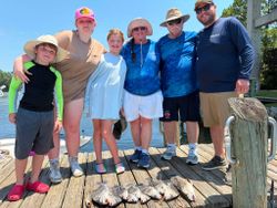 Successful fishing trip in Gulf Shores AL with fresh caught fish displayed on wooden dock