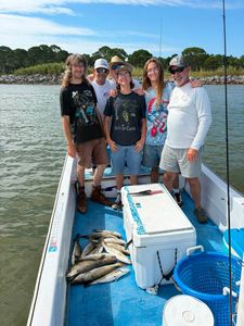 Successful speckled trout fishing trip on boat in Gulf Shores Alabama with fresh catch displayed on deck