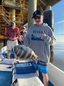 A photo of two people fishing for sheepshead in the Gulf Shores