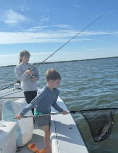 Three people enjoying a fishing trip in Cape Coral
