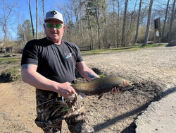 A person holding a rainbow trout fishing in Brethren