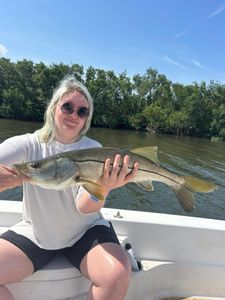A person fishing for a snook in Tampa