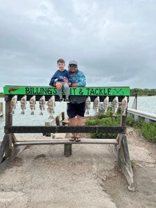 Five black drum fish hanging on display rack at fishing charter in Corpus Christi TX