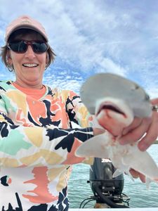 Fisherman catching a 9-inch fish in FL