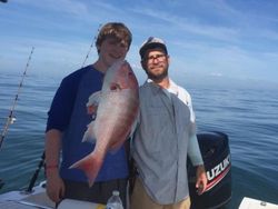 Two people fishing with a big fish in Port Orange