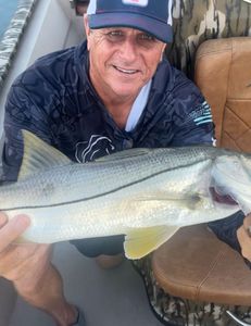 A person fishing for a snook in FL
