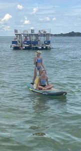 Paddleboard tour in Fort Walton Beach FL waters with tour boat in background