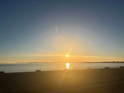 Sunset over calm waters viewed from Fort Walton Beach FL waterfront