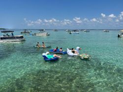 Clear turquoise waters with inflatable floats and boats anchored in Fort Walton Beach FL