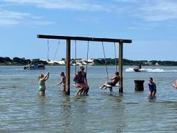 Water swing set in Fort Walton Beach FL with people enjoying water recreation activities