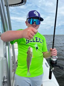 One fisherman catches a 12-inch fish in the waters of Midway