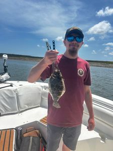 Angler with a southern flounder fish catch at Midway