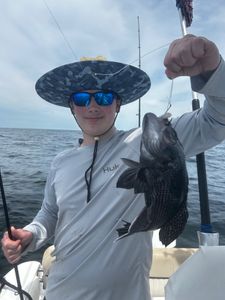 Catch of the day! A 15-inch sea bass fish caught at Midway.