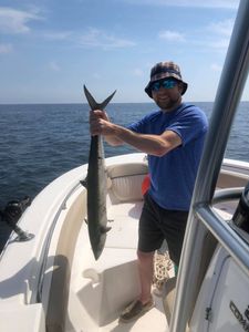 Angler catches a great barracuda during a fishing tour in Midway